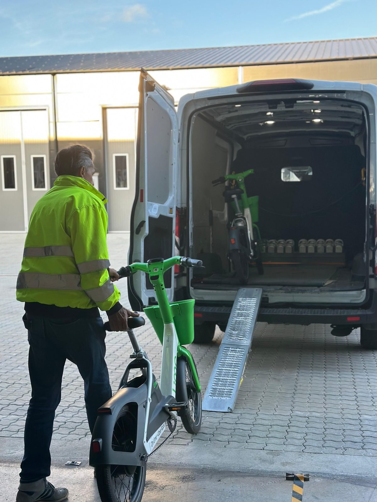 Binny Mobility crew loading e-bike for warehouse intake